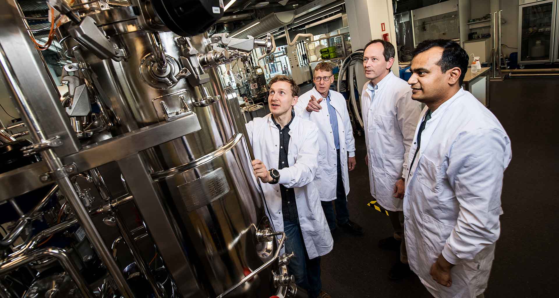 "Researchers in front of laboratory equipment at the Novo Nordisk Foundation Center for Biosustainability at DTU. Photo: Joachim Rode"